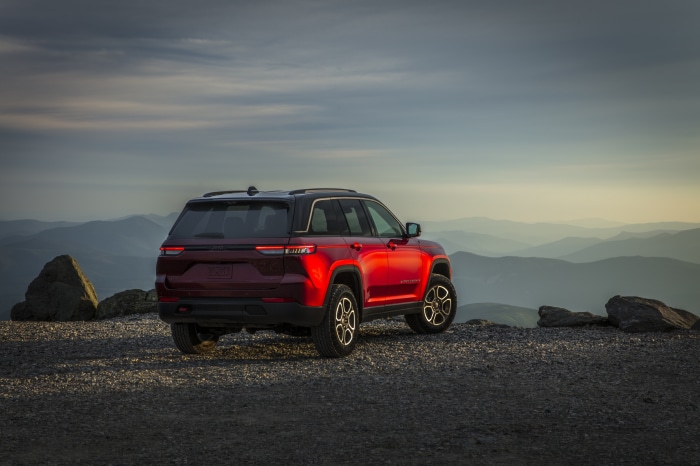 Red 2022 Jeep Grand Cherokee Trailhawk on mountain peak