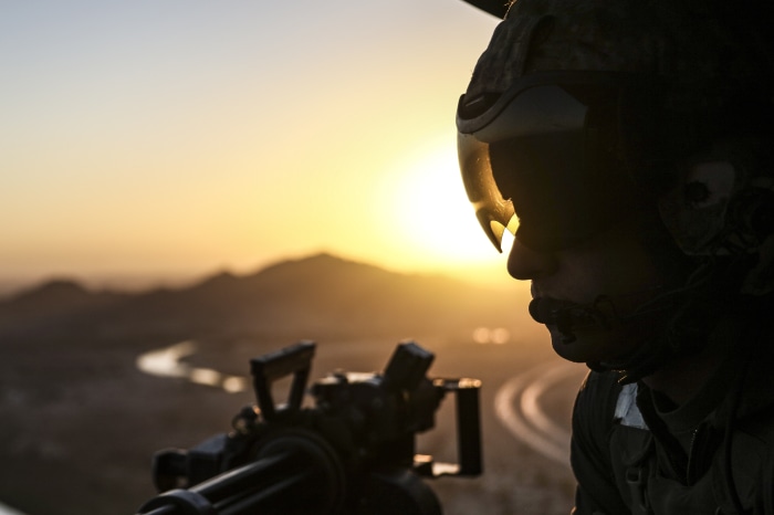 Marine with machine gun at sunset