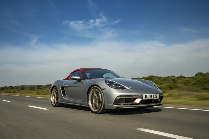 Silver Porsche Boxster Cabriolet driving on road