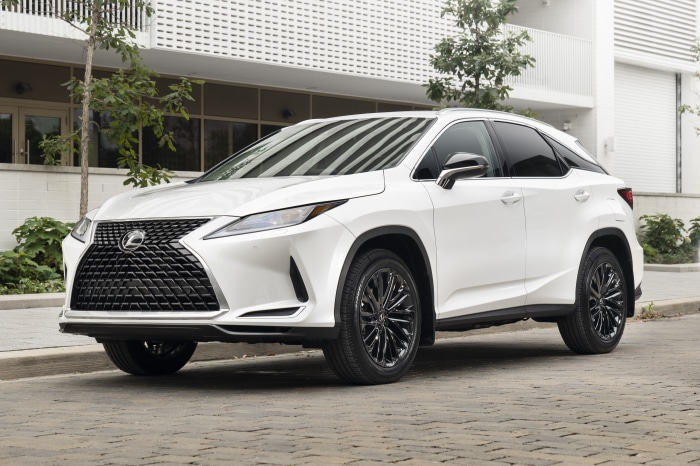 White Lexus RX 350 4K SUV parked on cobblestone street