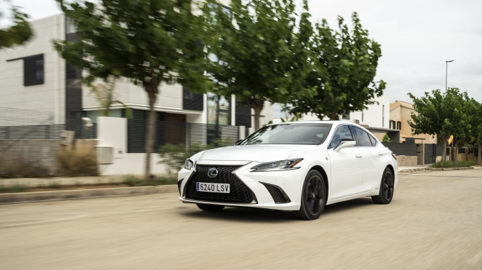 White Lexus ES 300h F SPORT driving on a street