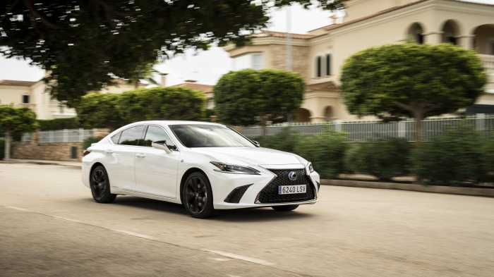 White Lexus ES 300h F SPORT driving on a street