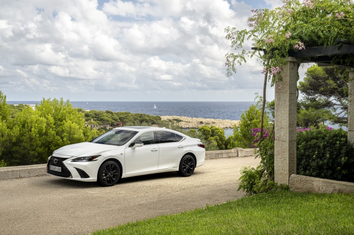White Lexus ES 300h F SPORT parked by the sea