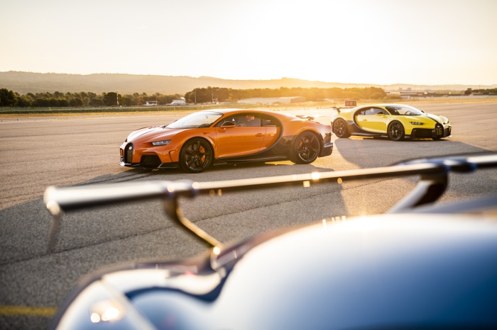 Bugatti Chiron Supercars on a Racetrack at Sunset