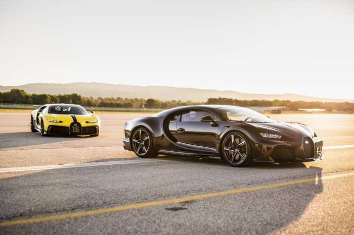 Two Bugatti Chirons on a Racetrack