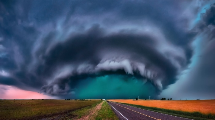 Stormy sky over a rural landscape with a road