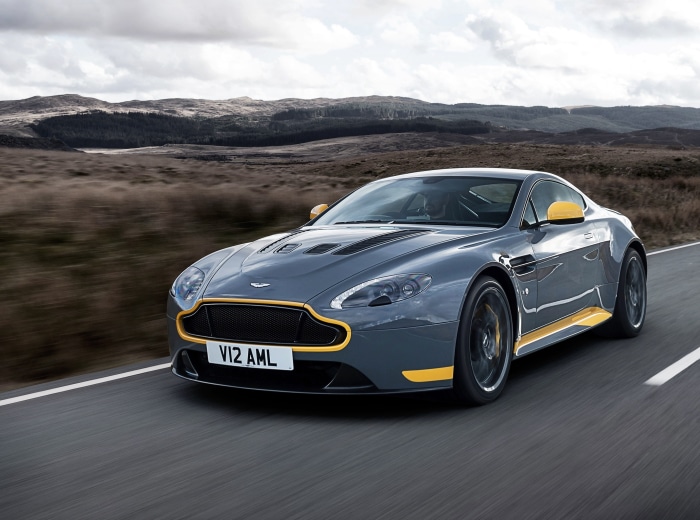 Aston Martin V12 Vantage driving on a road