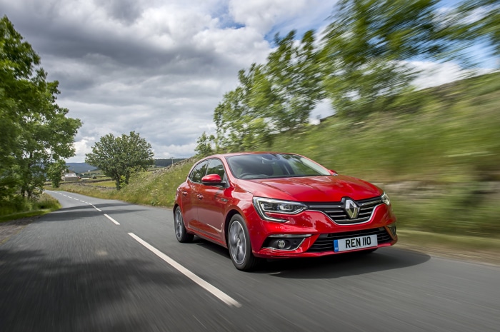 Red Renault Megane driving on a country road