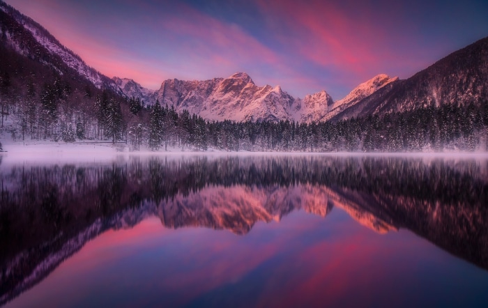 Snowy Mountains Reflected in a Lake at Sunset
