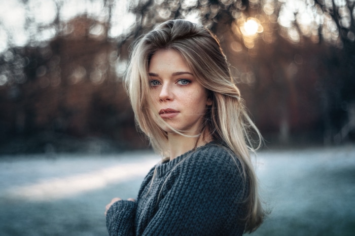 Woman with blonde hair wearing a sweater