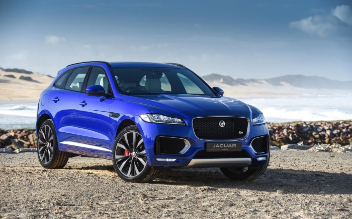 Blue Jaguar F-PACE 4K SUV on a Beach