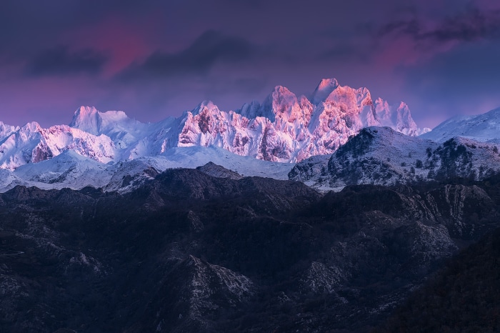 Snow-capped mountains at sunset