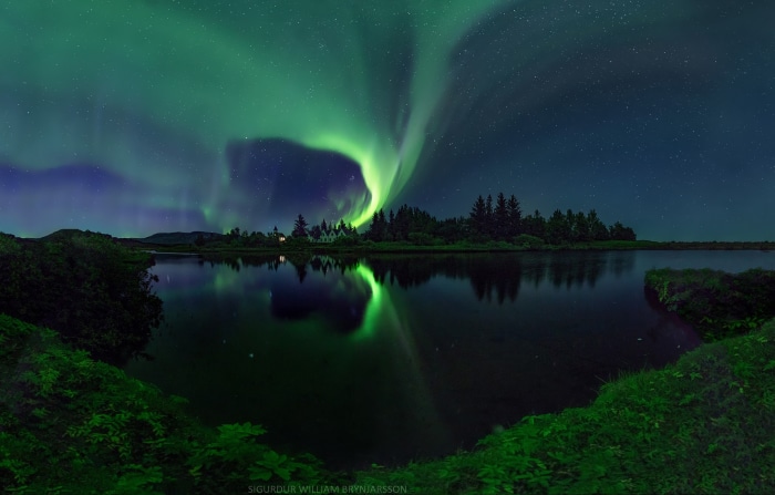 Aurora Borealis Reflection Over Lake at Night