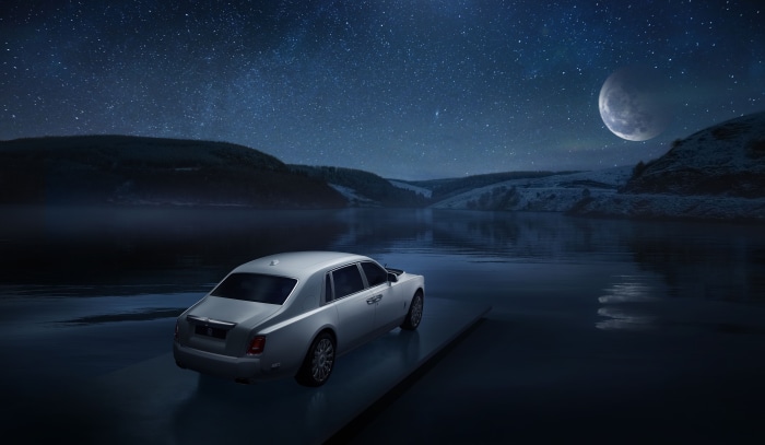 Rolls-Royce Phantom on a platform by a lake at night