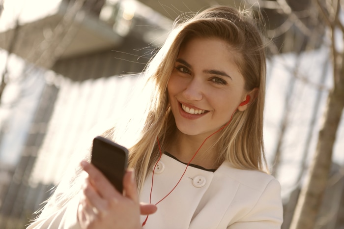 Woman with headphones and phone