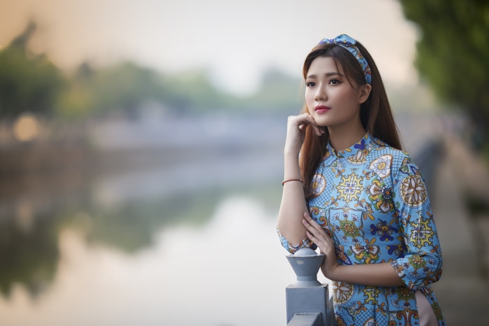 Asian woman in traditional dress by a river