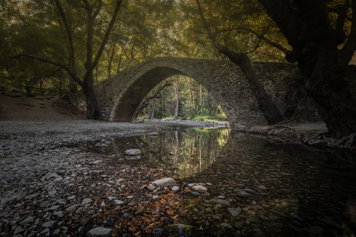Stone bridge over a river in a forest, Cyprus