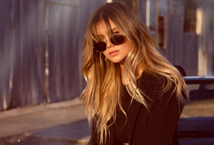 Woman with blonde hair wearing sunglasses