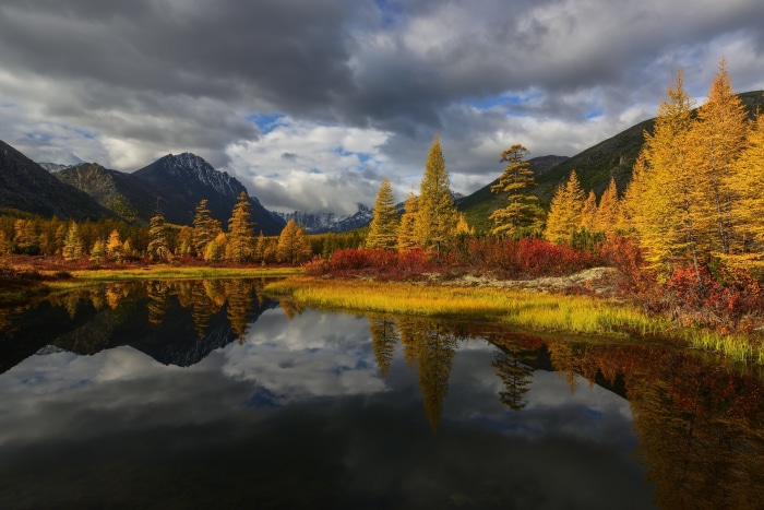 Autumn lake reflection with mountains and trees