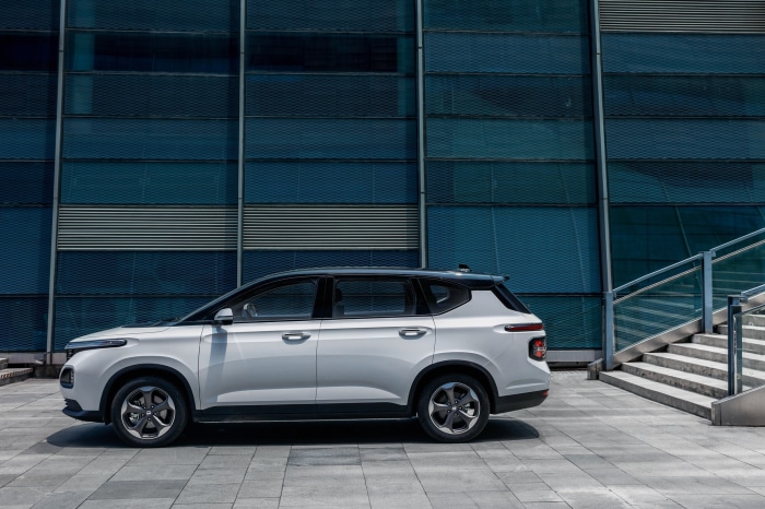 Baojun RM-5 parked in front of a modern building