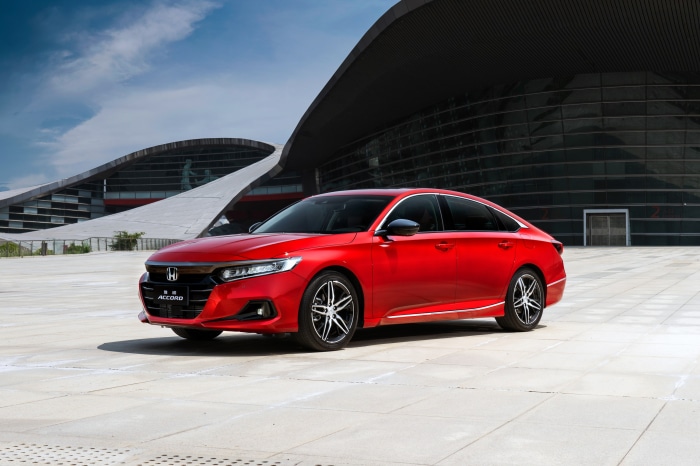 Red Honda Accord Sport Turbo in front of modern building