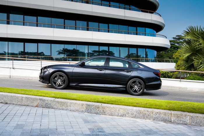 Dark gray Honda Accord Sport Hybrid parked by a modern building