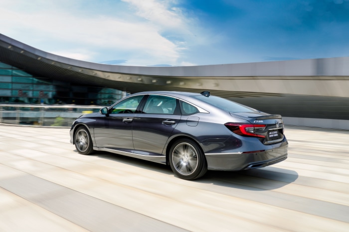 Honda Accord Sport Hybrid driving near modern building