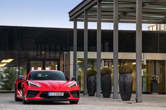 Red Chevrolet Corvette Stingray parked outside building