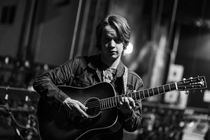 Billy Strings playing acoustic guitar