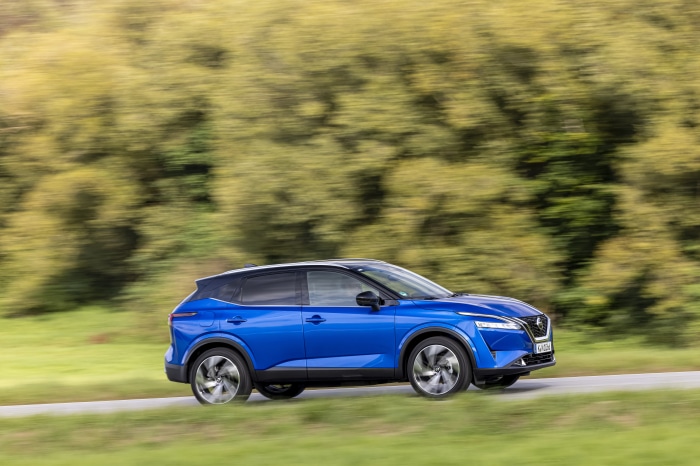 Blue Nissan Qashqai SUV driving on a road