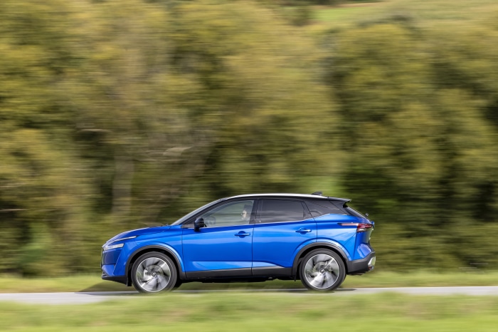 Blue Nissan Qashqai SUV driving on a road