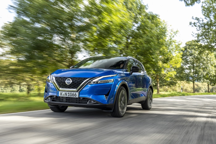 Blue Nissan Qashqai SUV driving on a road