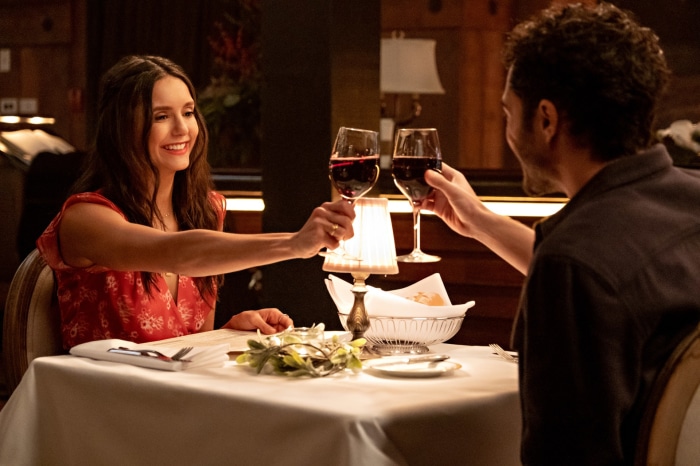 Nina Dobrev and Darren Barnet toasting wine