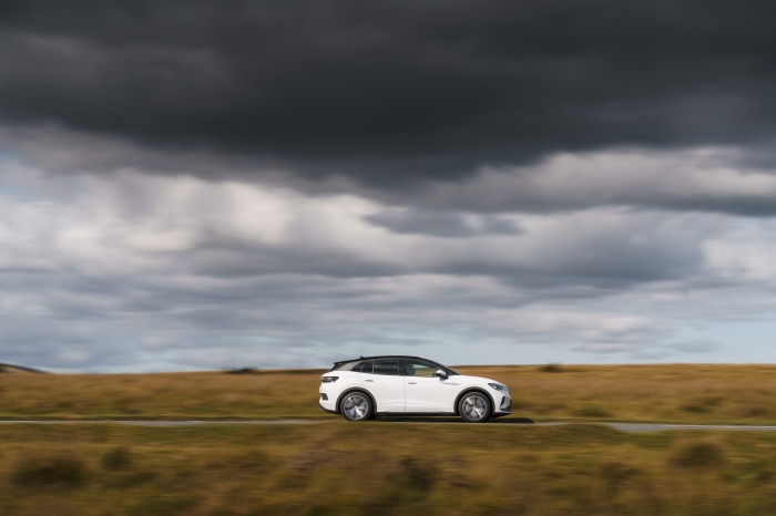 White Volkswagen ID.4 driving on a road