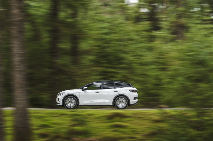 White Volkswagen ID.4 driving on a road