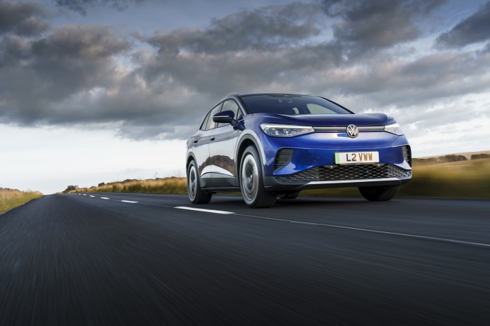 Blue Volkswagen ID.4 electric car driving on a road