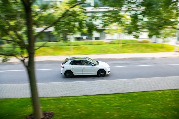 White Skoda Fabia driving on a road