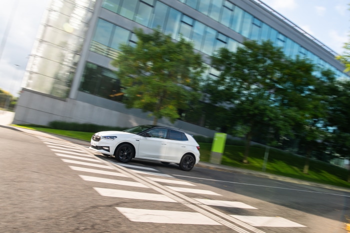 White Skoda Fabia driving over crosswalk