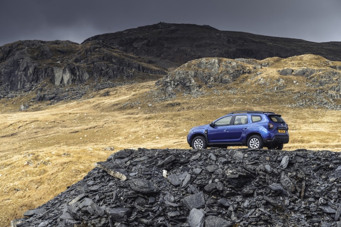 Blue Dacia Duster SUV on rocky terrain