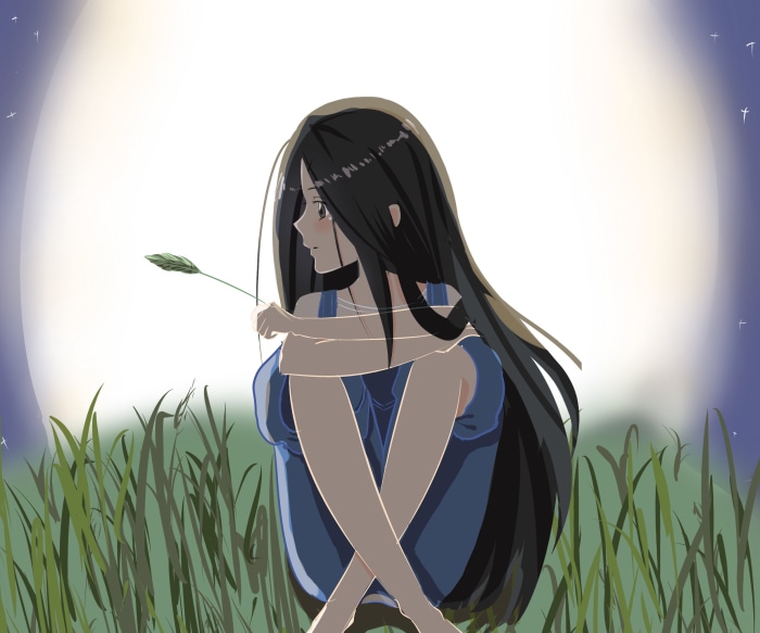 Girl in a field with a leaf