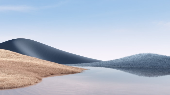 Lake and rolling hills with blue sky