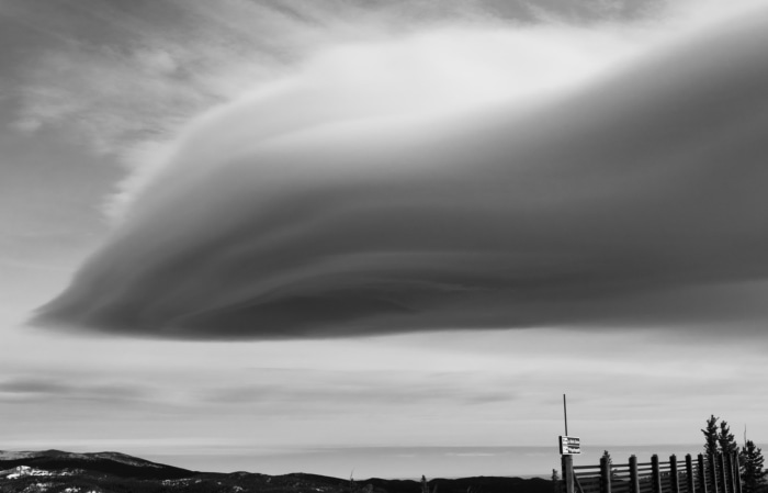 Lenticular cloud formation over mountains