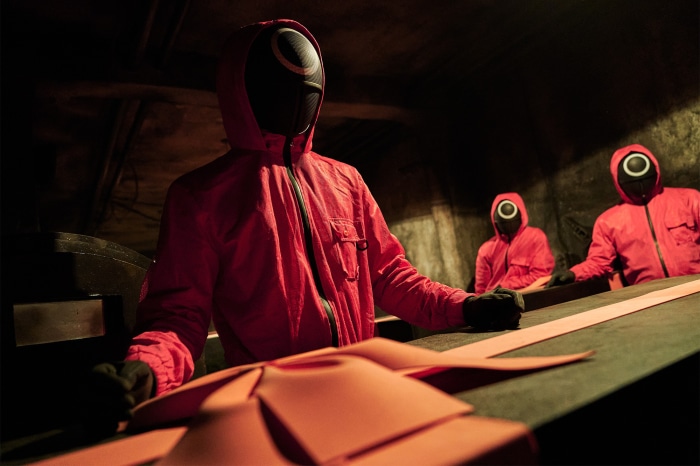 Squid Game guards in red suits and masks