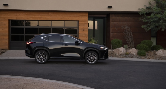 Black Lexus NX 350 AWD parked in front of a modern house