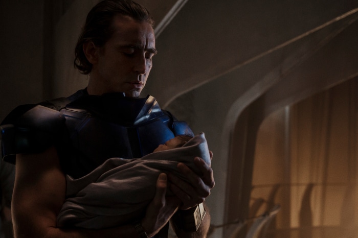 Lee Pace as Brother Day holding a baby in Foundation
