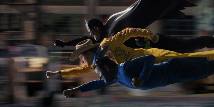 Three men in costumes flying