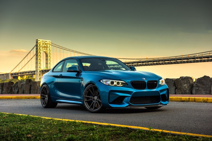Blue BMW M2 Coupe on Road with Bridge