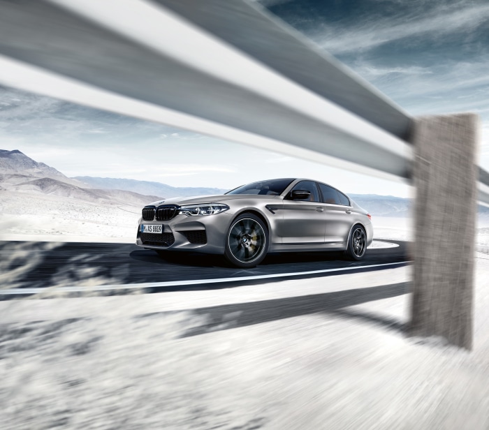BMW M5 Competition driving on a desert road