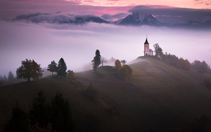 Church on a foggy hill at sunrise