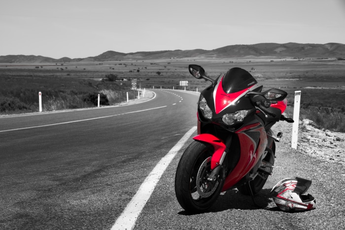 Red and black Honda CB1000R motorcycle on a road
